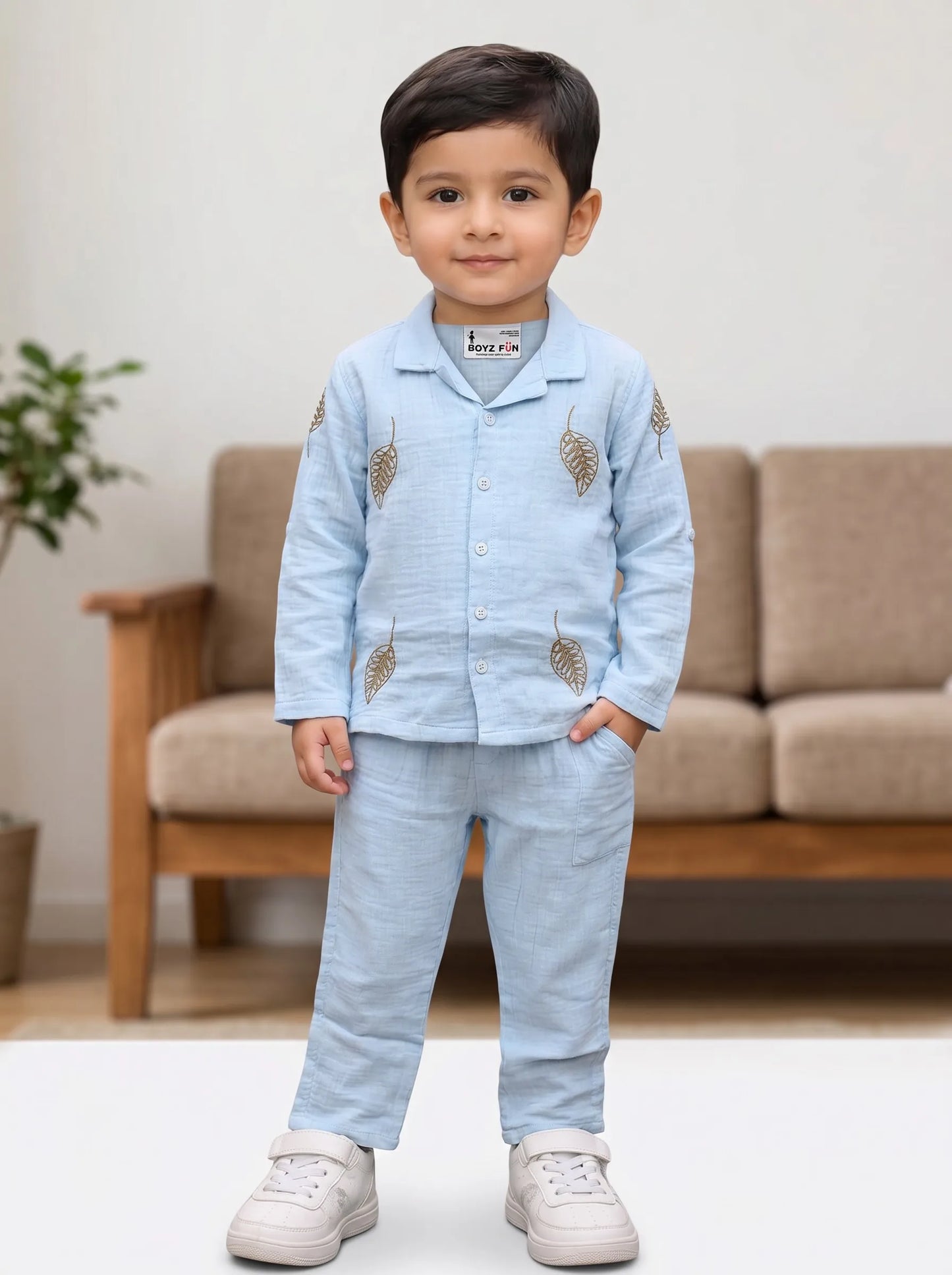 Boy in a sky blue leaf print muslin shirt and trouser co-ord set by Boyz Fun