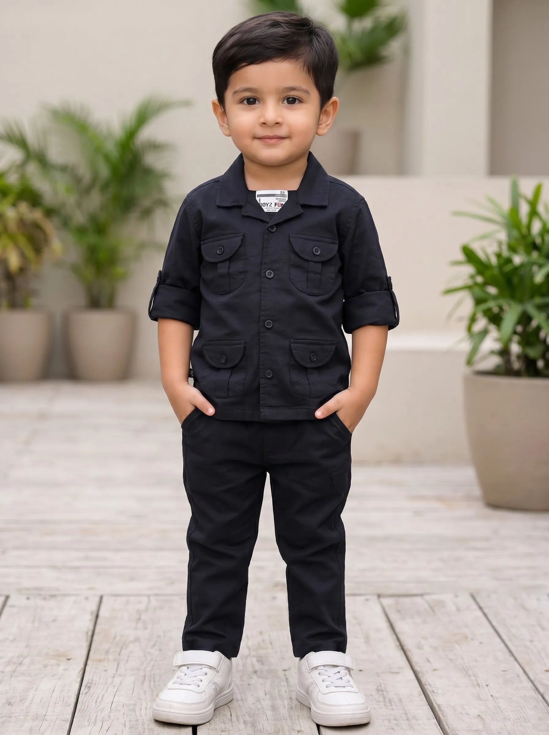Boy in a black co-ord shirt and matching pant set by Boyz Fun