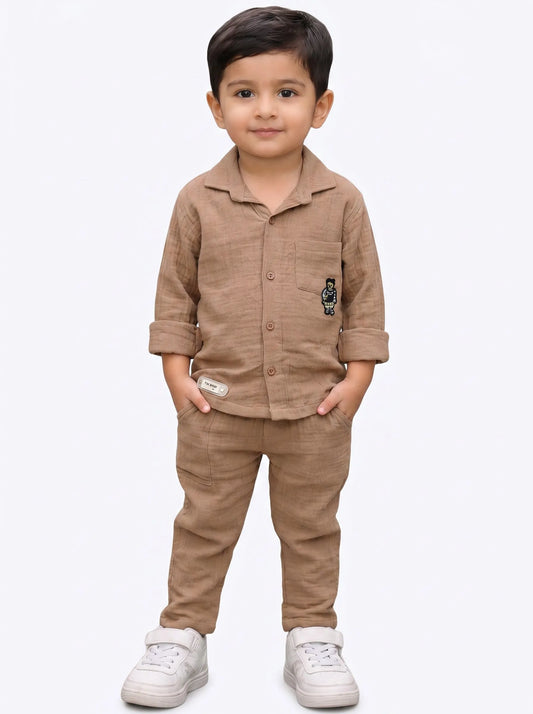 Boy in a biscuit solid muslin shirt and matching trouser co-ord set by Boyz Fun