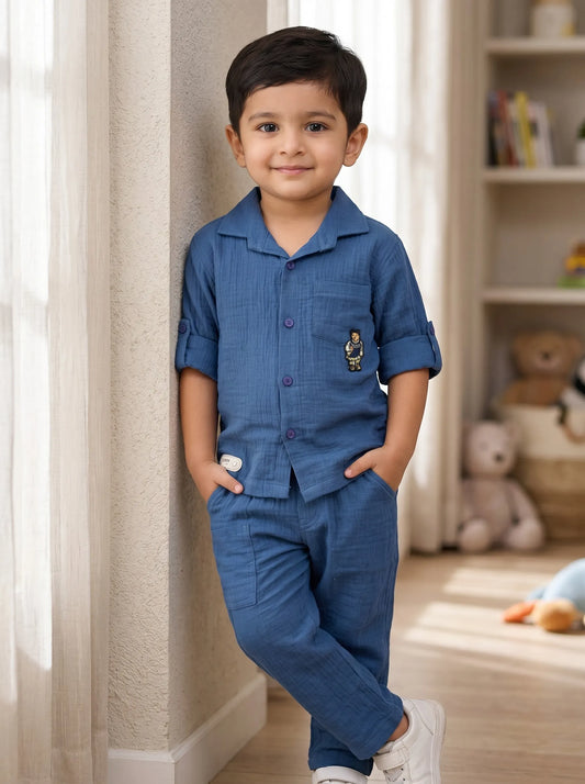 Boy in a blue solid muslin shirt and matching trouser co-ord set by Boyz Fun