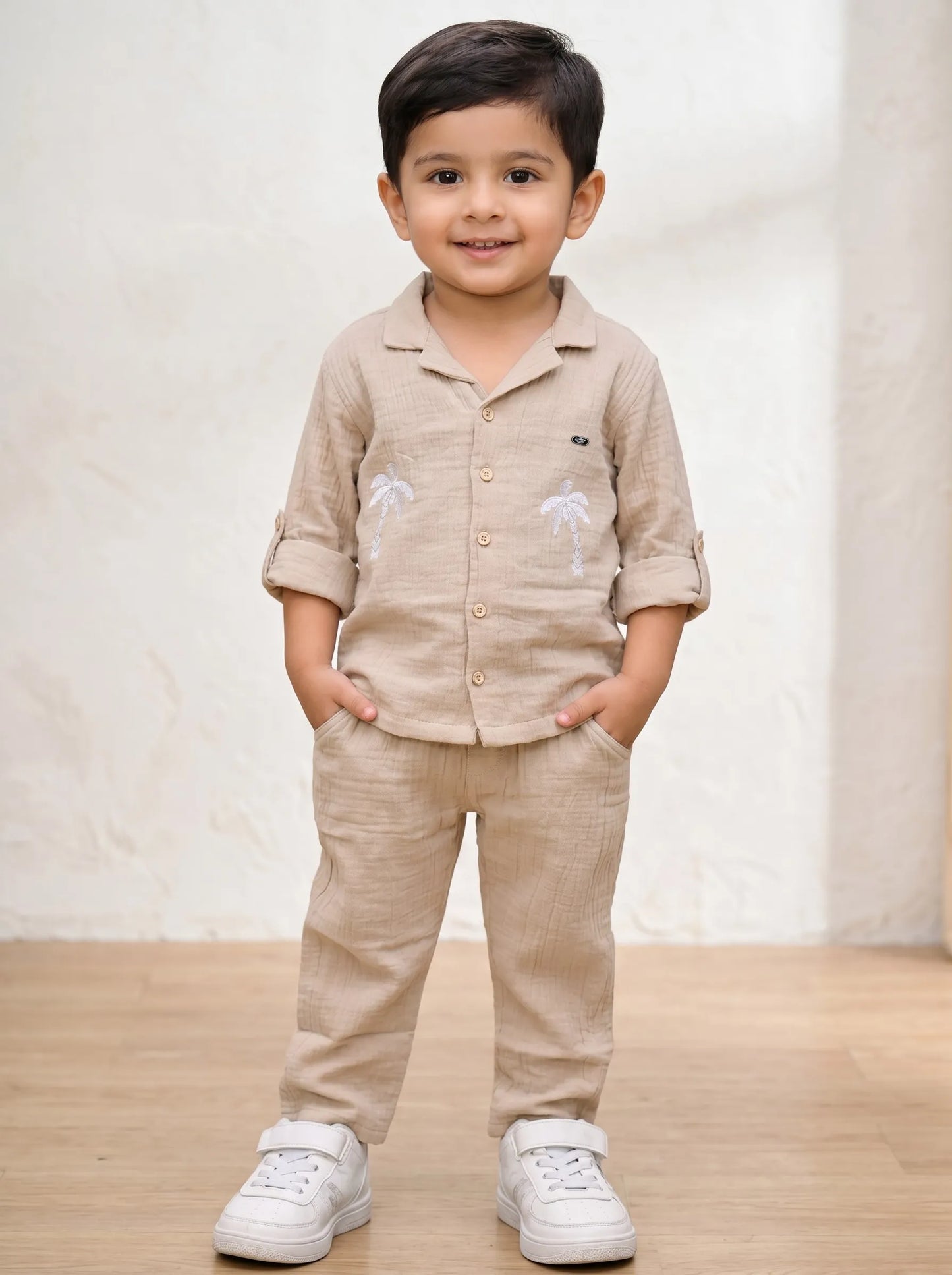 Boy in a biscuit palm tree print muslin co-ord set by Boyz Fun