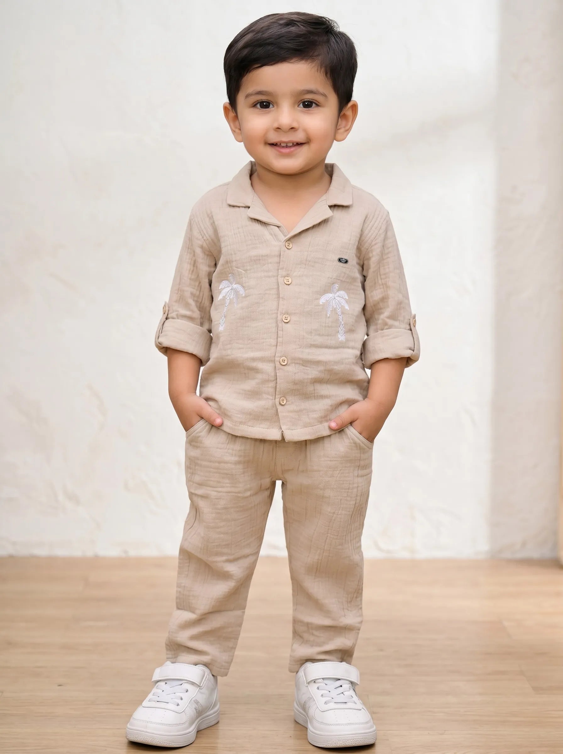 Boy in a biscuit palm tree print muslin co-ord set by Boyz Fun