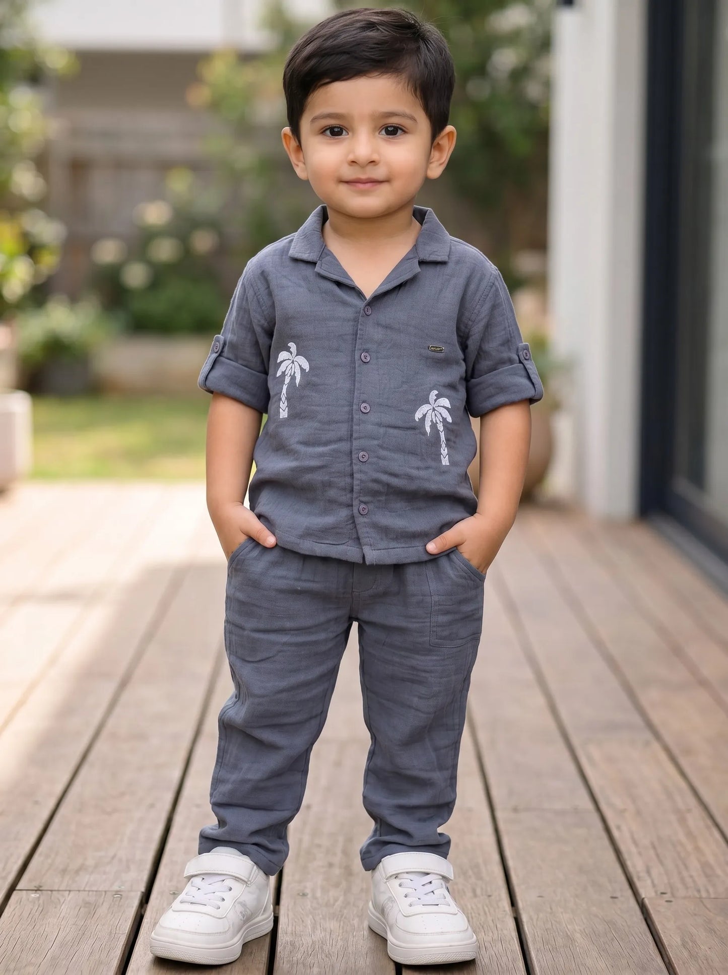 Boy in a blue palm tree print muslin co-ord set by Boyz Fun
