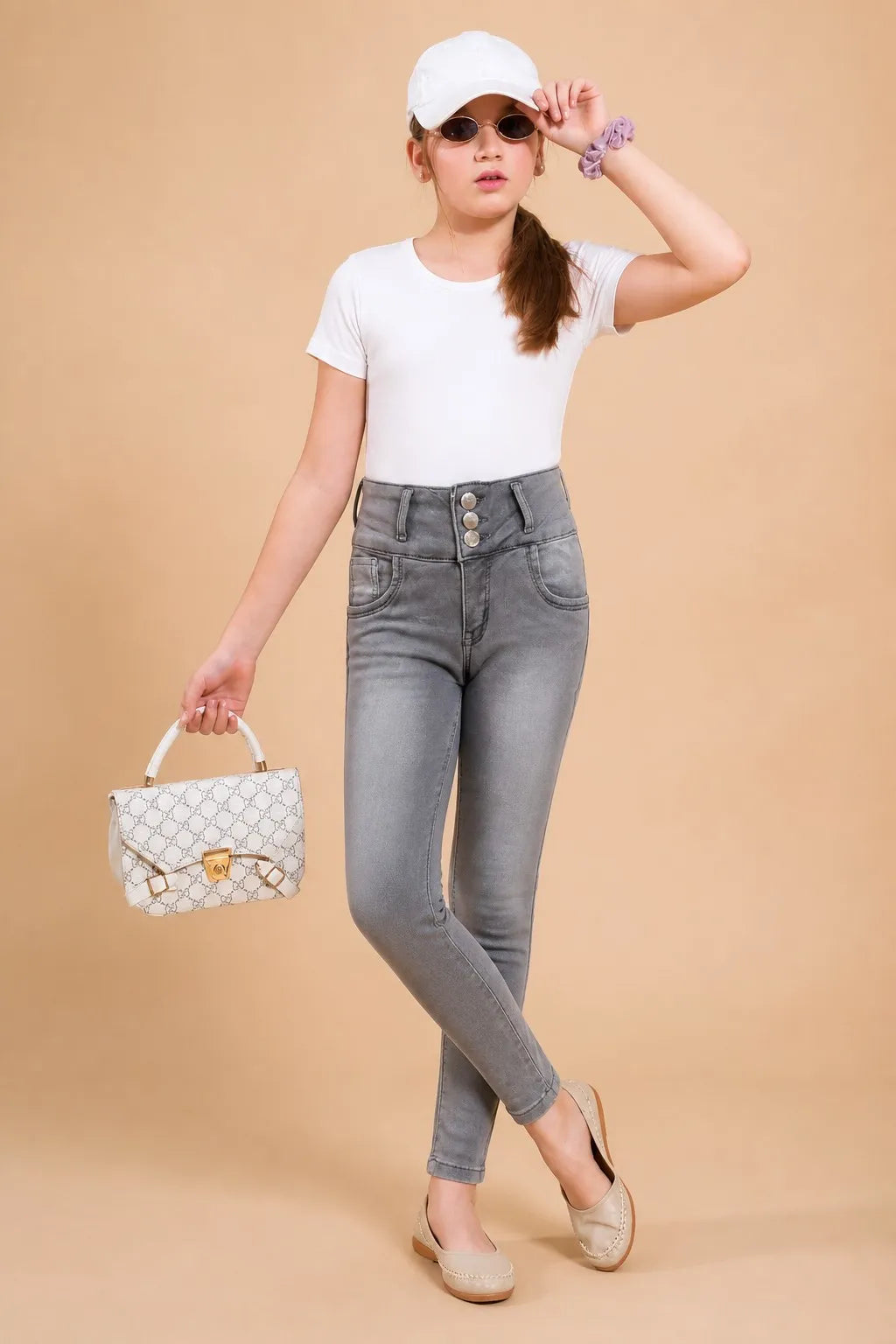 Girl in grey triple-button ankle skinny jeans with a white tee, Gilly Billy