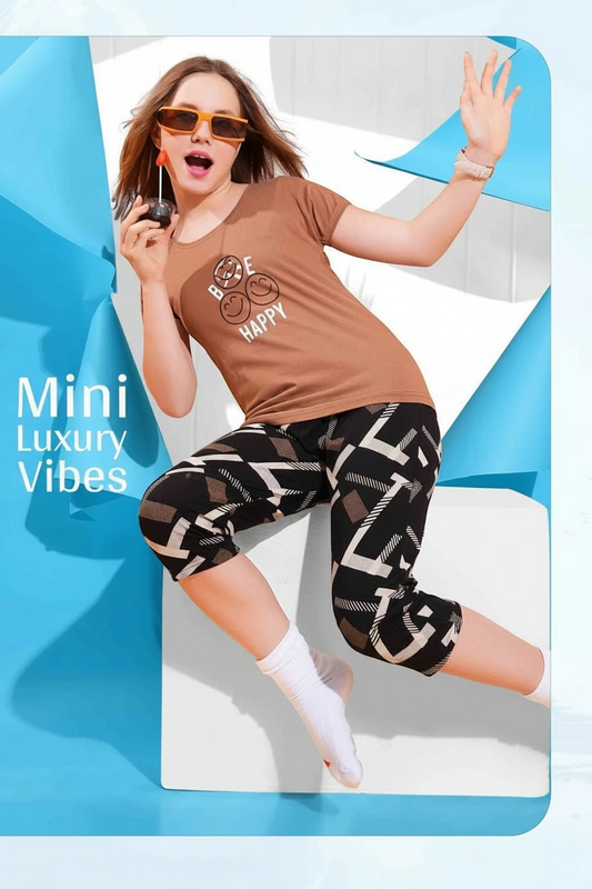 Girl in a brown Be Happy tee and black printed capri, In Touche kids night suit