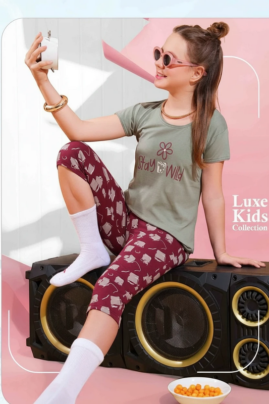 Girl in a green Stay Wild tee and red printed pyjama, In Touche kids night suit