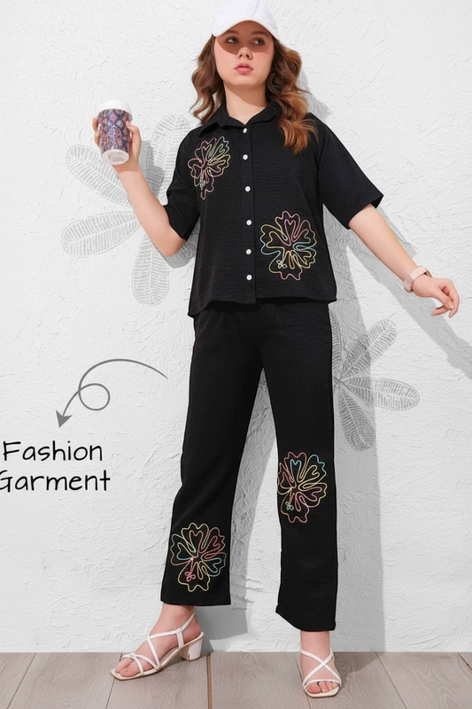 Girl in a black cut-work top and matching black trousers, In Touche girls co-ord set