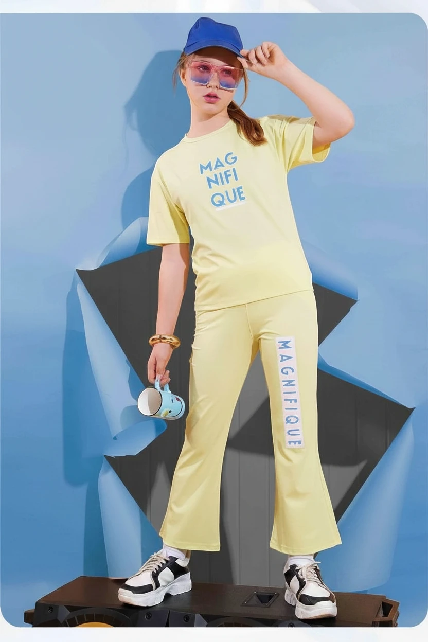 Girl in a yellow Magnifique print top and matching flared trousers by In Touche