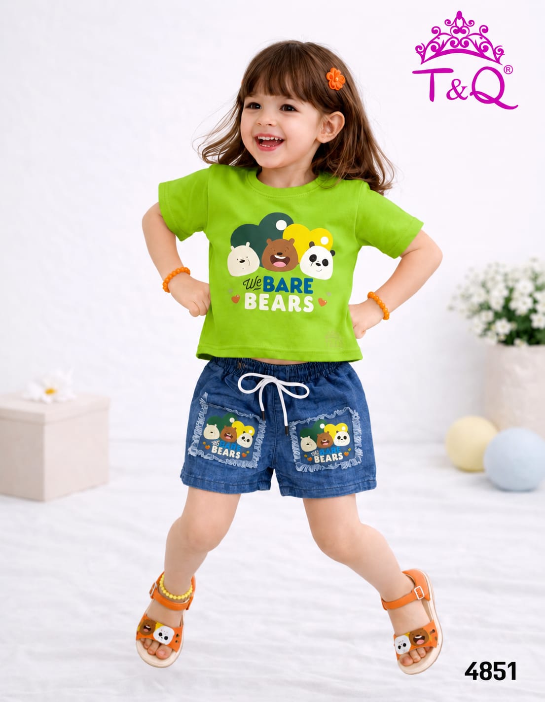 Girl in a green bear print t-shirt and denim shorts set by T and Q