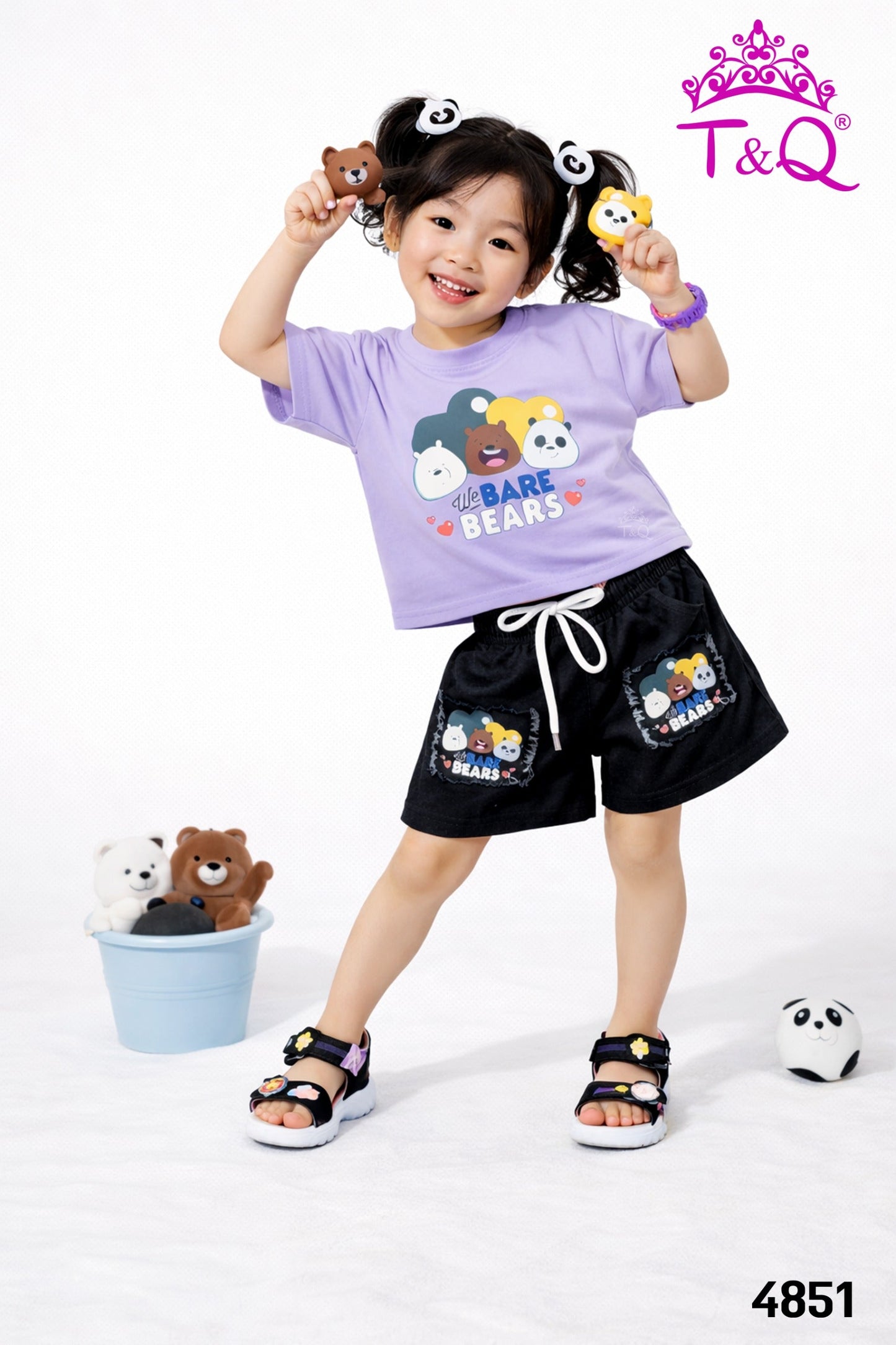 Girl in a purple bear print t-shirt and black shorts set by T and Q