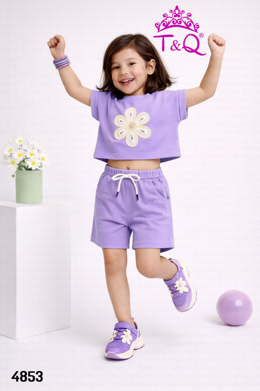 Girl in a purple flower applique crop top and shorts set by T and Q