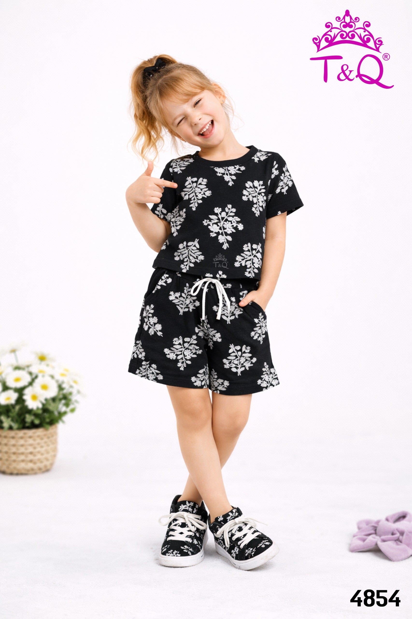 Girl in a black floral print top and shorts set by T and Q