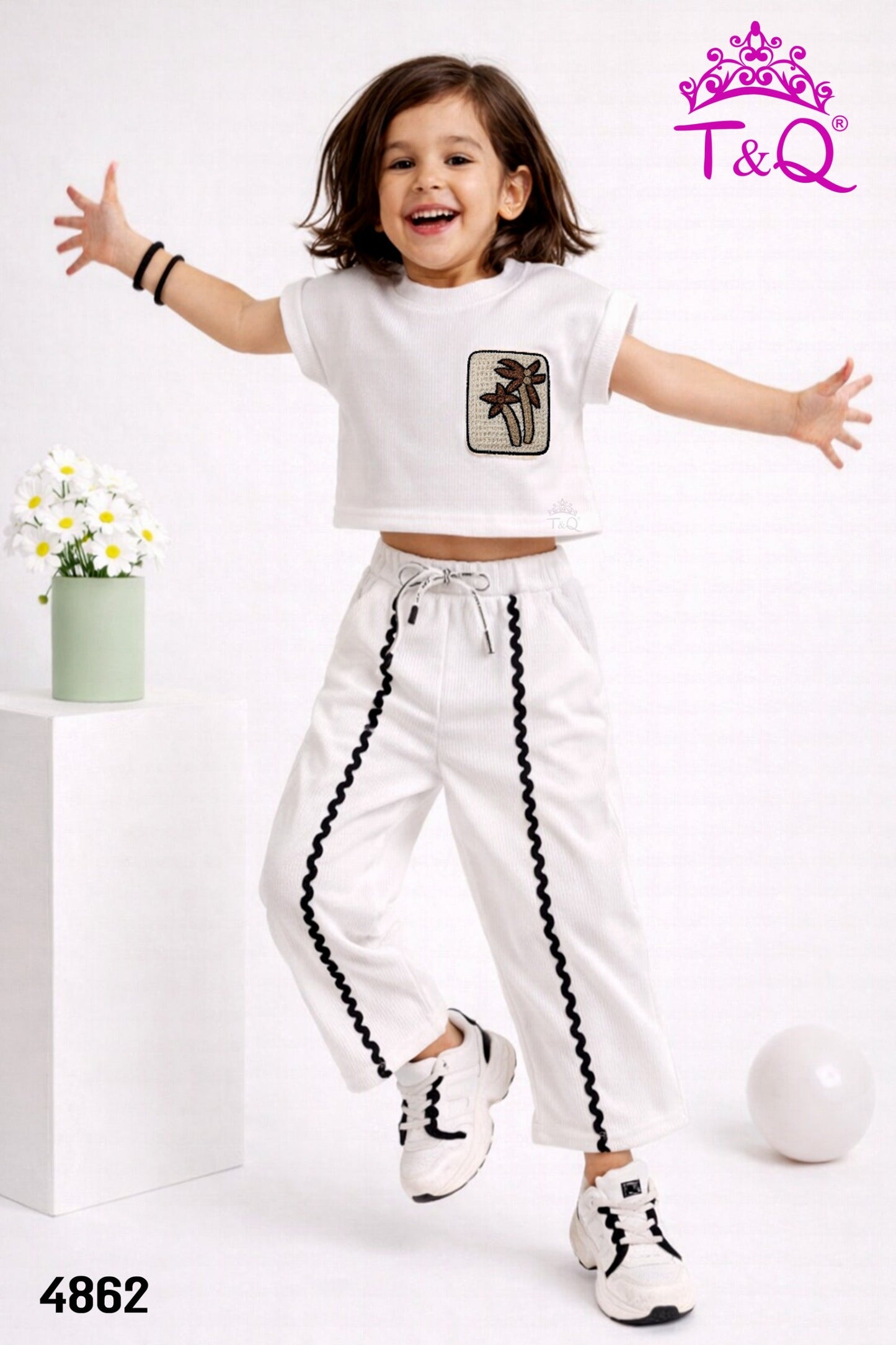 Girl in a white palm patch top and side-stripe trousers by T and Q
