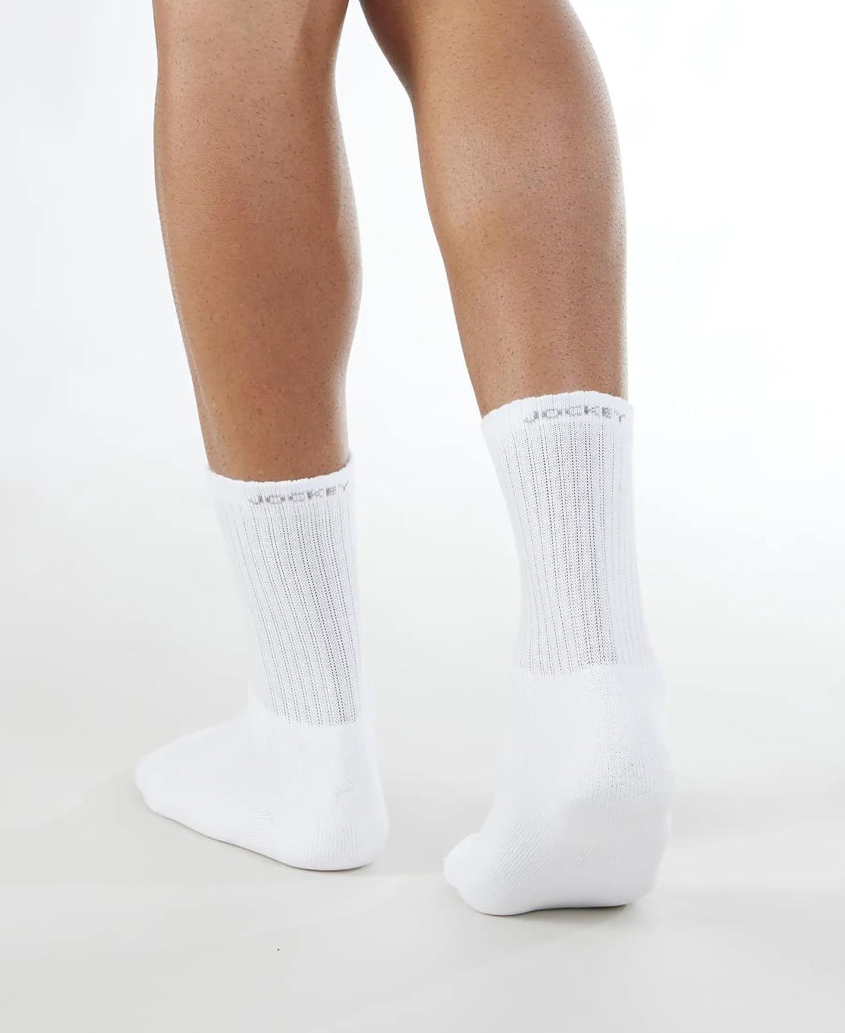 Front view of Jockey men's white crew length socks on a model