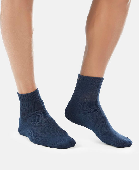 Model wearing Jockey navy ankle length cotton terry socks