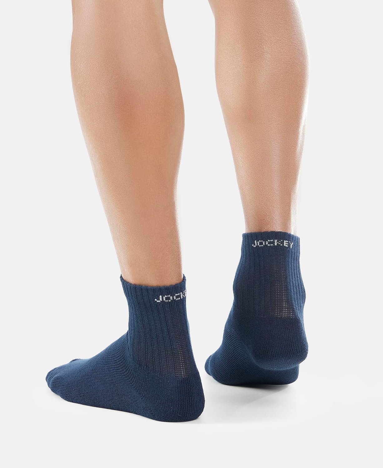 Front view of Jockey navy ankle length cotton terry socks on a model