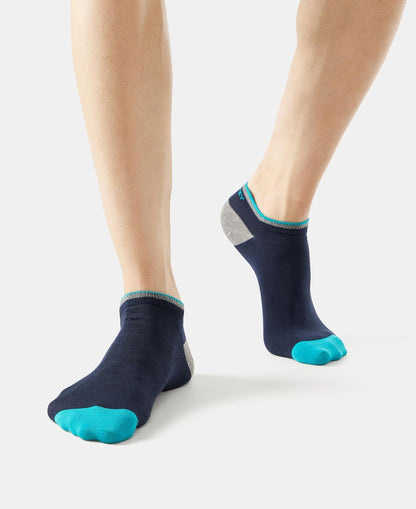 Jockey low show socks in navy with turquoise toe, worn by a model
