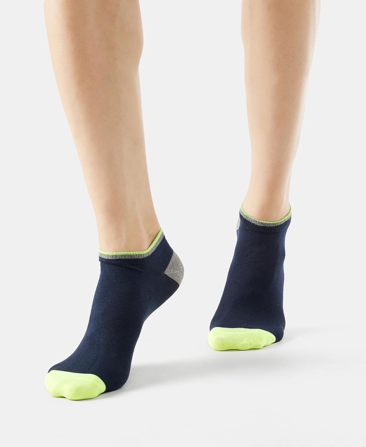 Jockey navy low show socks with lime green toe, front view on model