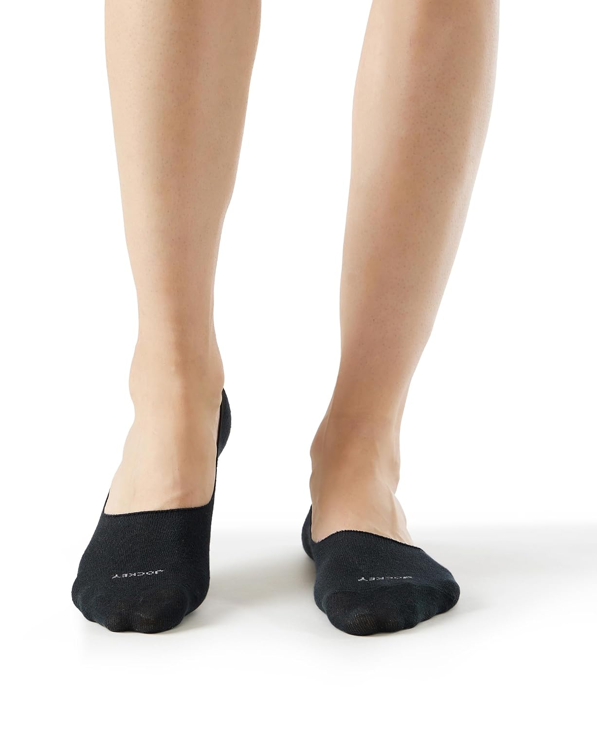 Model wearing Jockey navy no show athleisure socks, hidden below the ankle