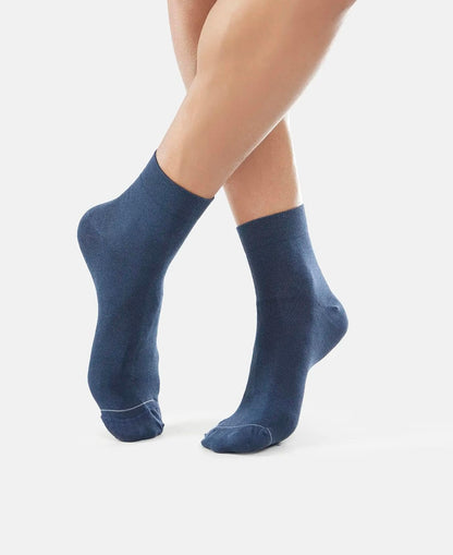 Side view of Jockey navy international ankle length socks worn by a model