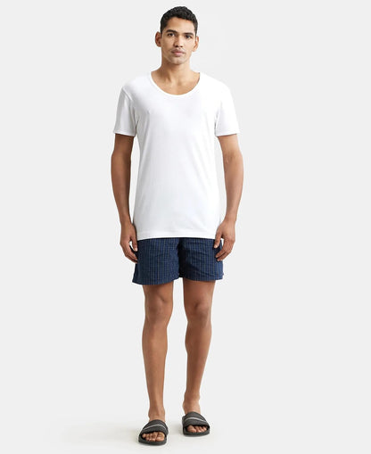 Full-length view of a model in a Jockey white half sleeve vest and shorts