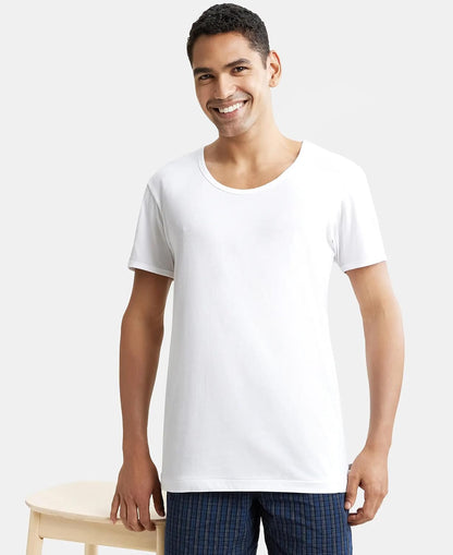 Model wearing a Jockey white half sleeve cotton vest, standing pose