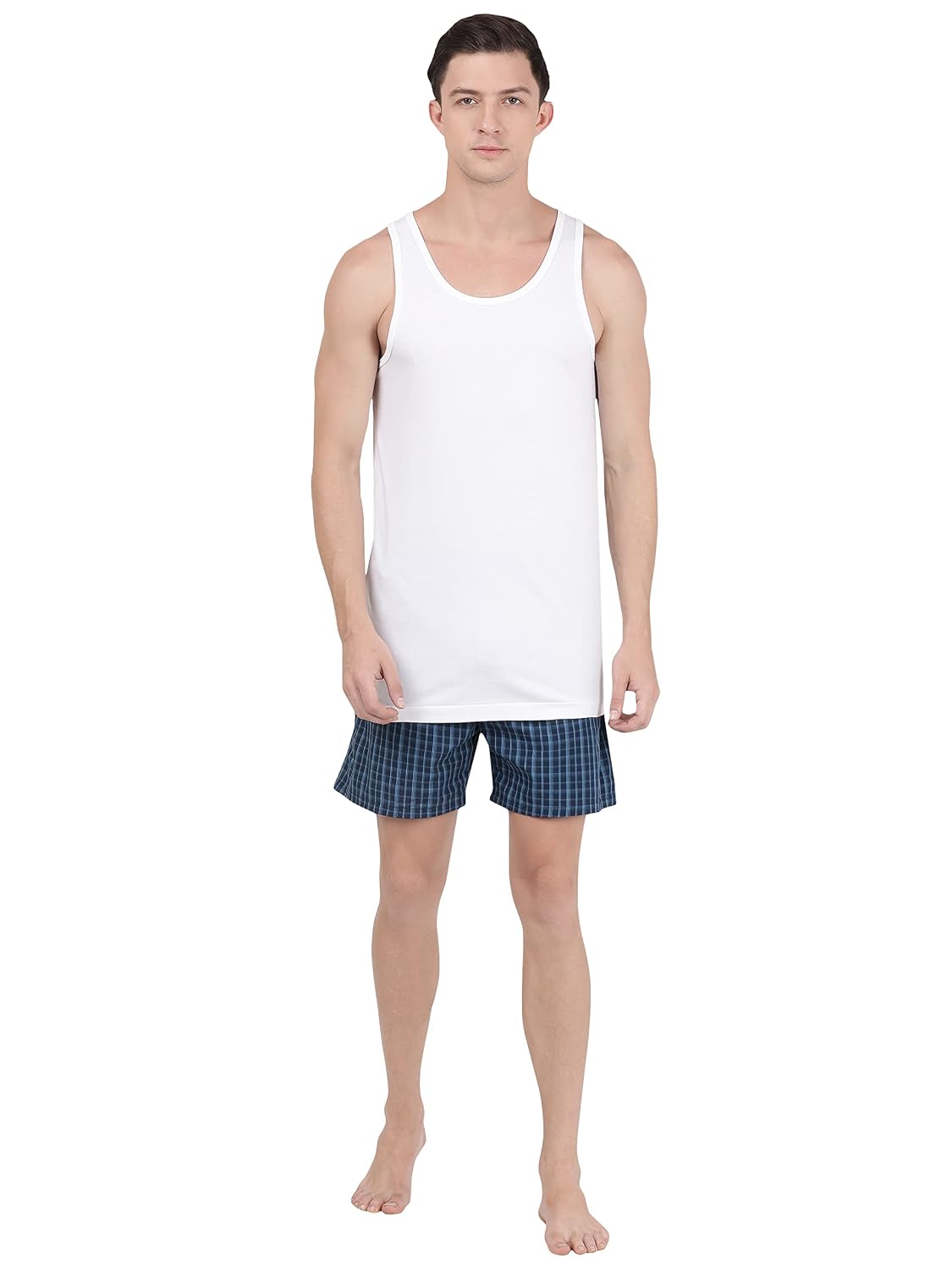 Full-length view of a model in a Jockey white sleeveless vest and shorts