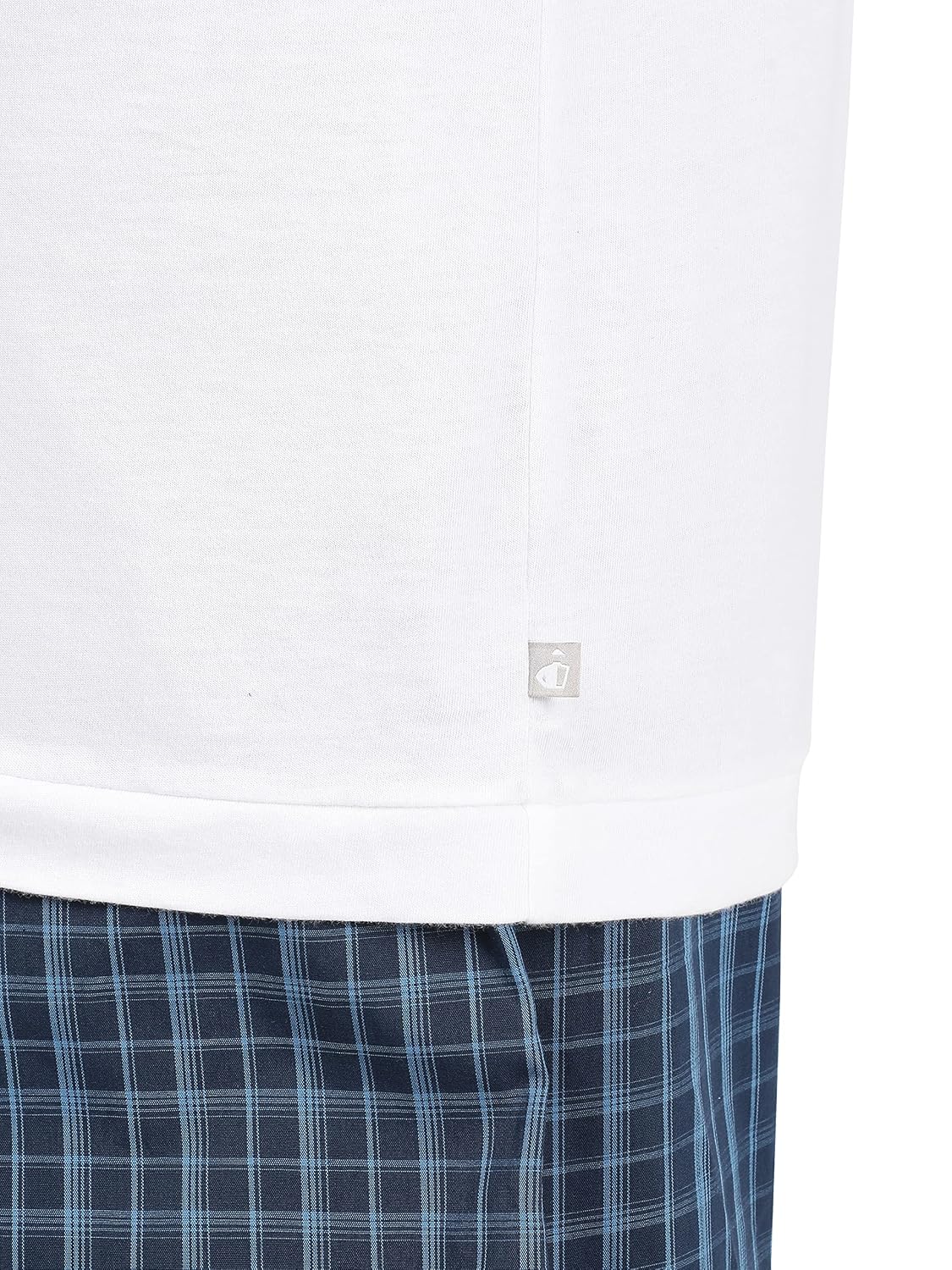 Hem detail of a Jockey men's white sleeveless cotton vest over checked shorts