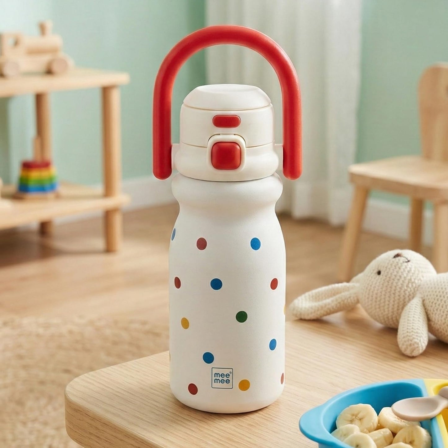 Red Mee Mee Hydro Flow insulated sipper cup on a table with toys