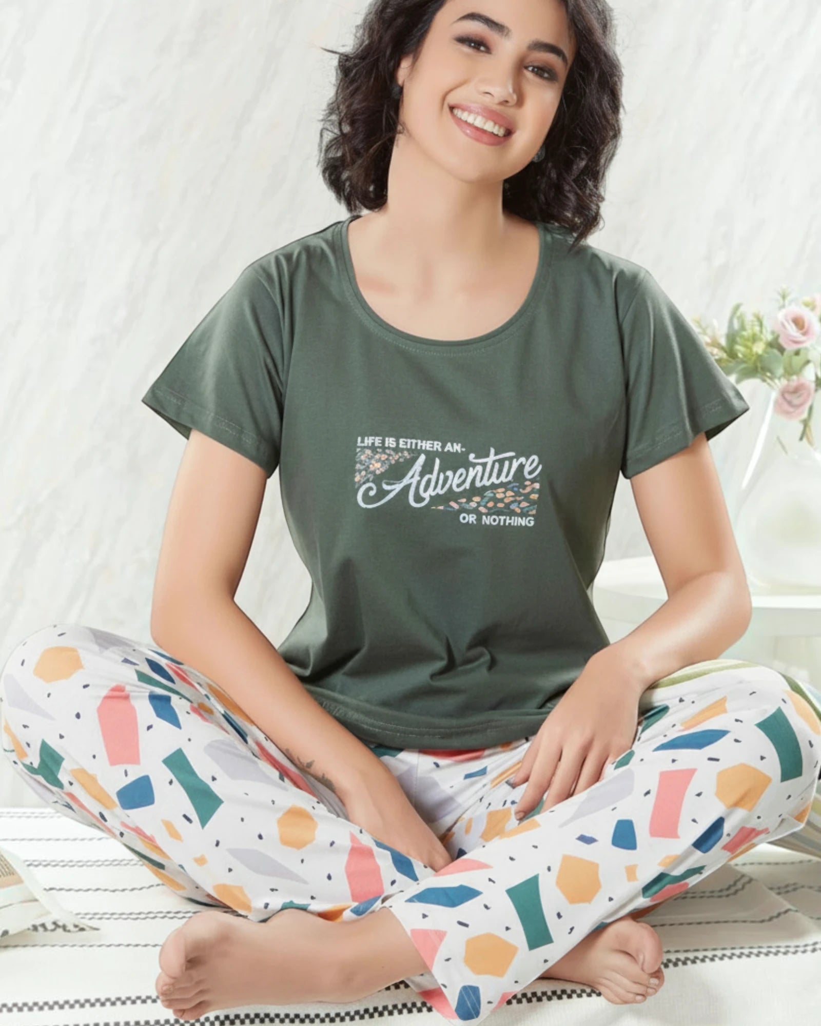 Woman in an olive green Adventure slogan tee and printed white pyjama, In Touche cotton night suit