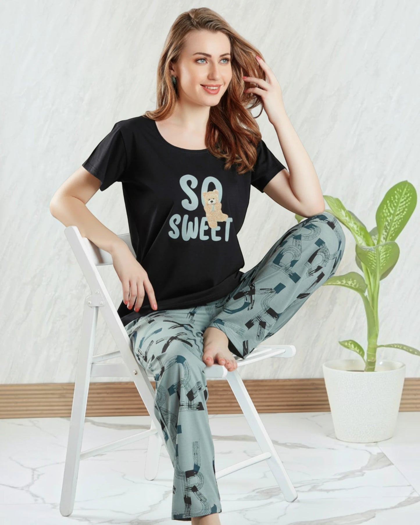 Woman in a black So Sweet teddy print tee and light printed pyjama, In Touche cotton night suit