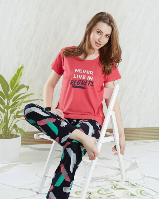 Woman in a red No Regrets slogan tee and printed pyjama, In Touche cotton night suit
