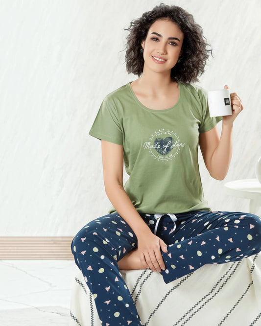 Woman in an olive green Made of Stars tee and navy printed pyjama, In Touche night suit