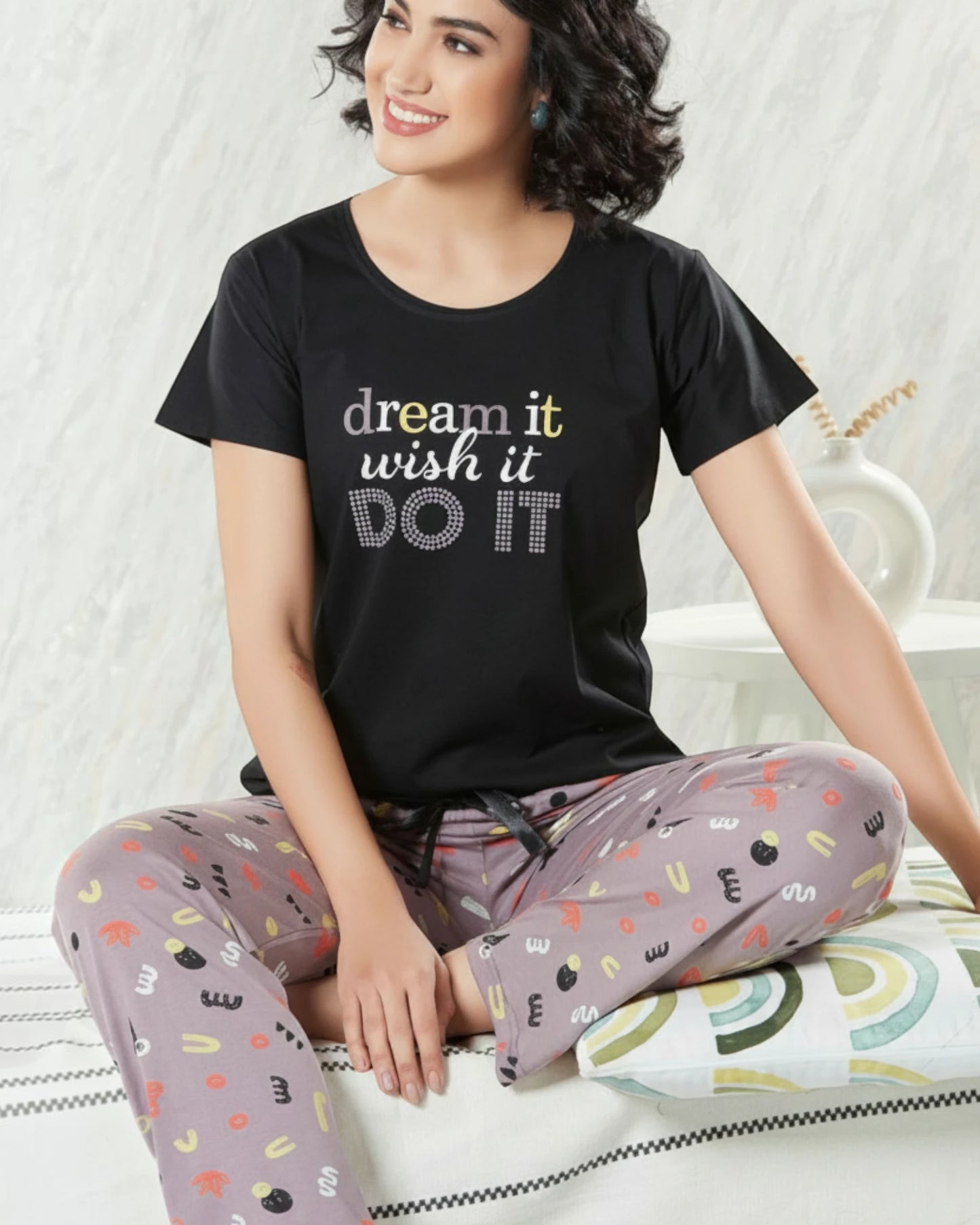 Woman in a black Dream It slogan tee and grey printed pyjama, In Touche night suit