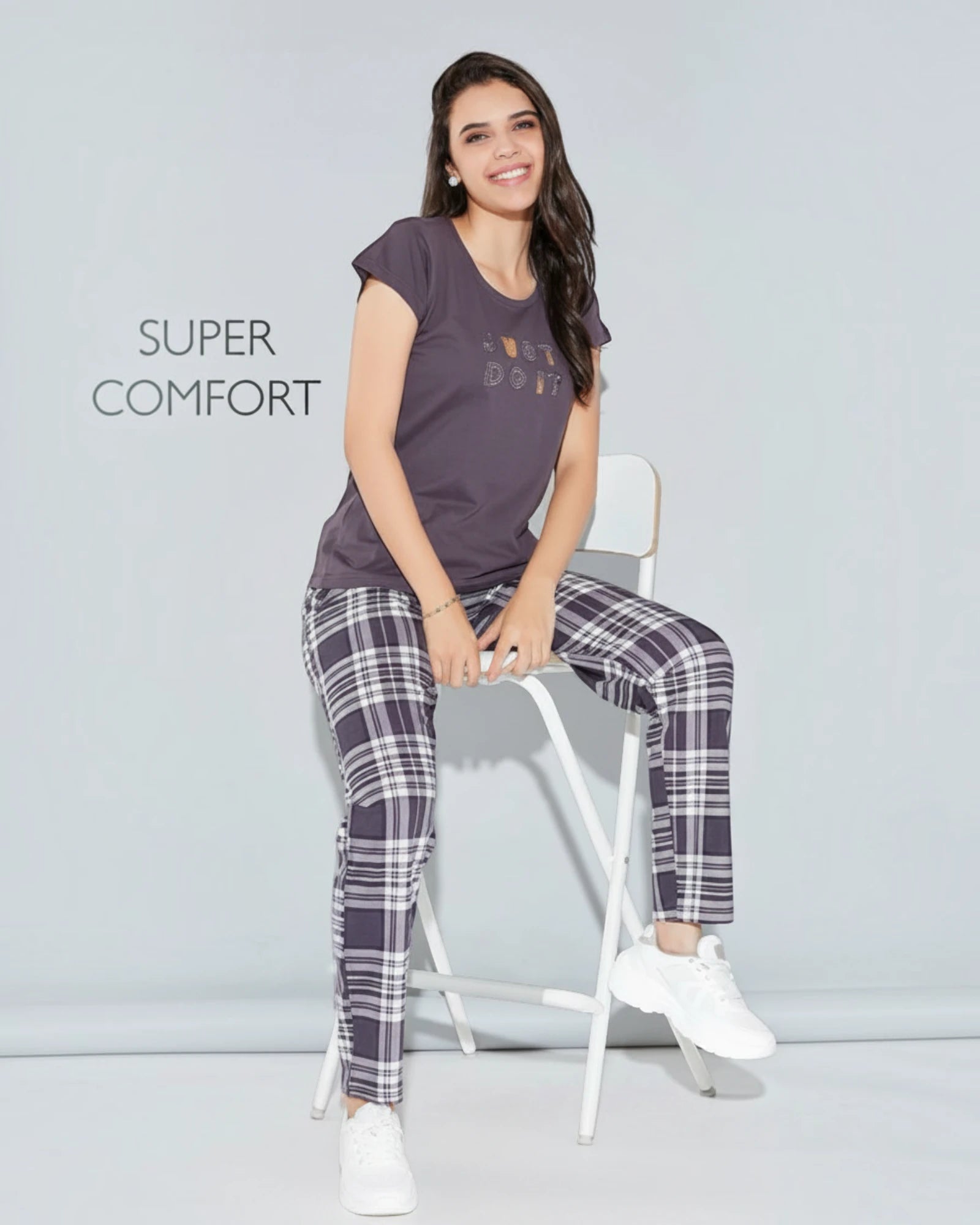 Woman in a purple slogan tee and checked pyjama, In Touche super comfort night suit