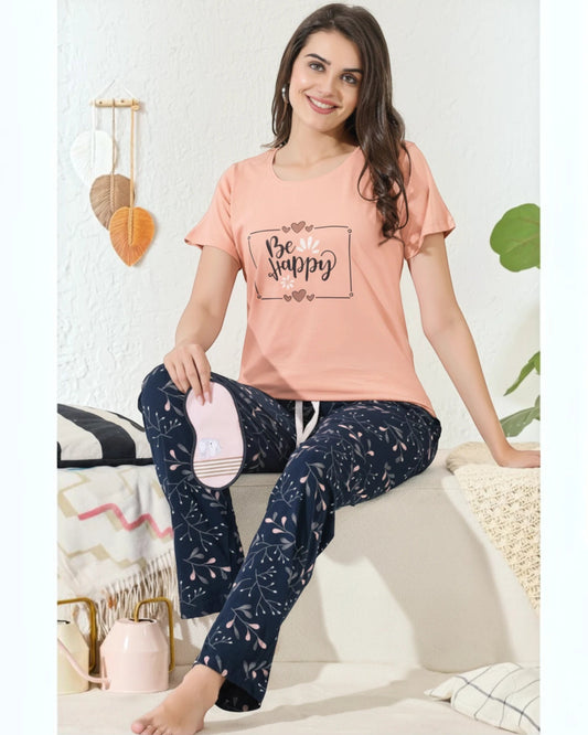 Woman in a peach Be Happy tee and navy printed pyjama, In Touche cotton night suit