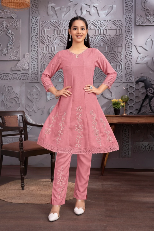 Girl in a pink embroidered kurti and matching pant set by Bimbee