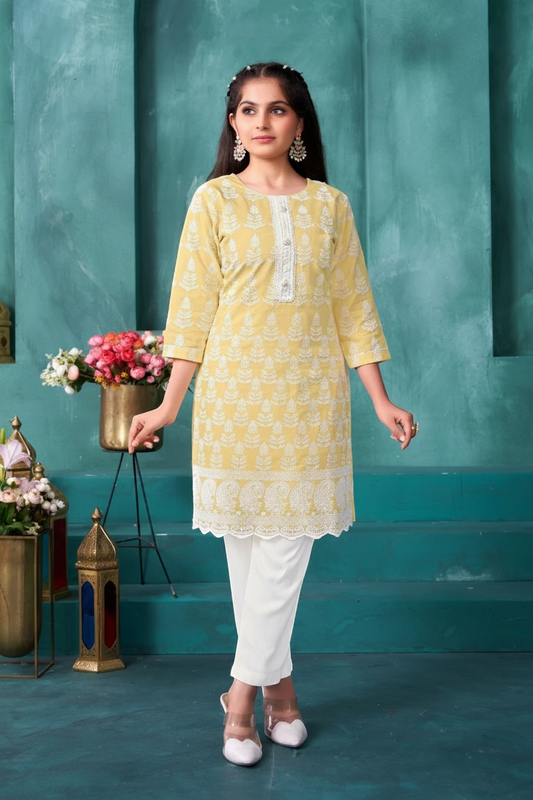 Girl in a lemon yellow chikankari kurti and white pant set by Bimbee