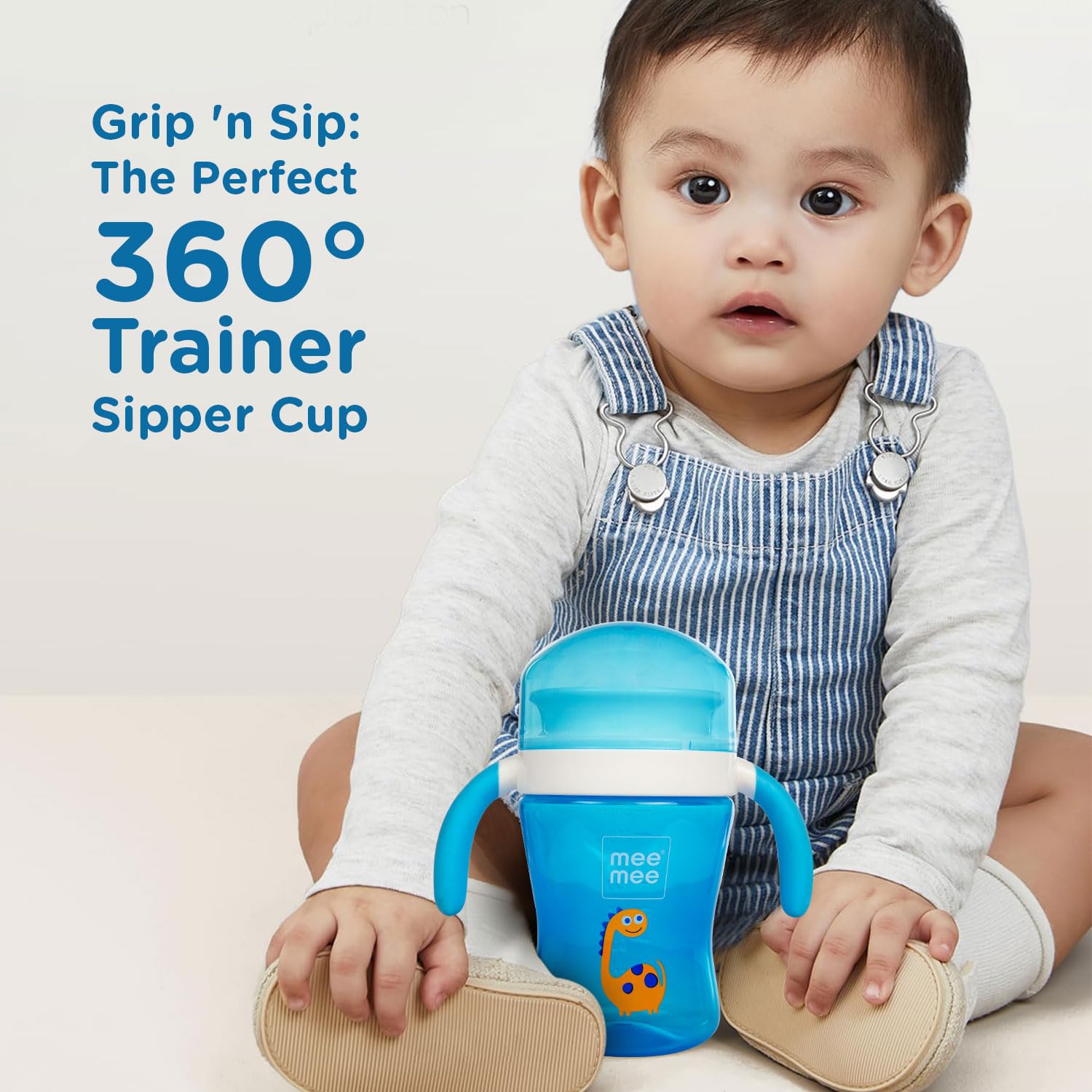 Baby drinking from the blue Mee Mee 360 degree trainer sipper cup