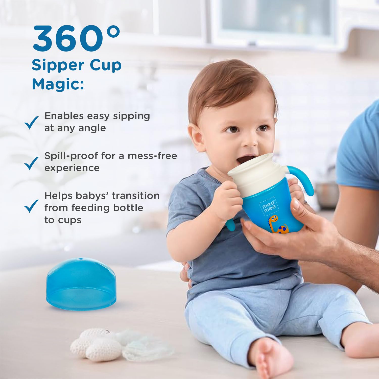 Baby using the blue Mee Mee 360 degree trainer cup with its lid removed