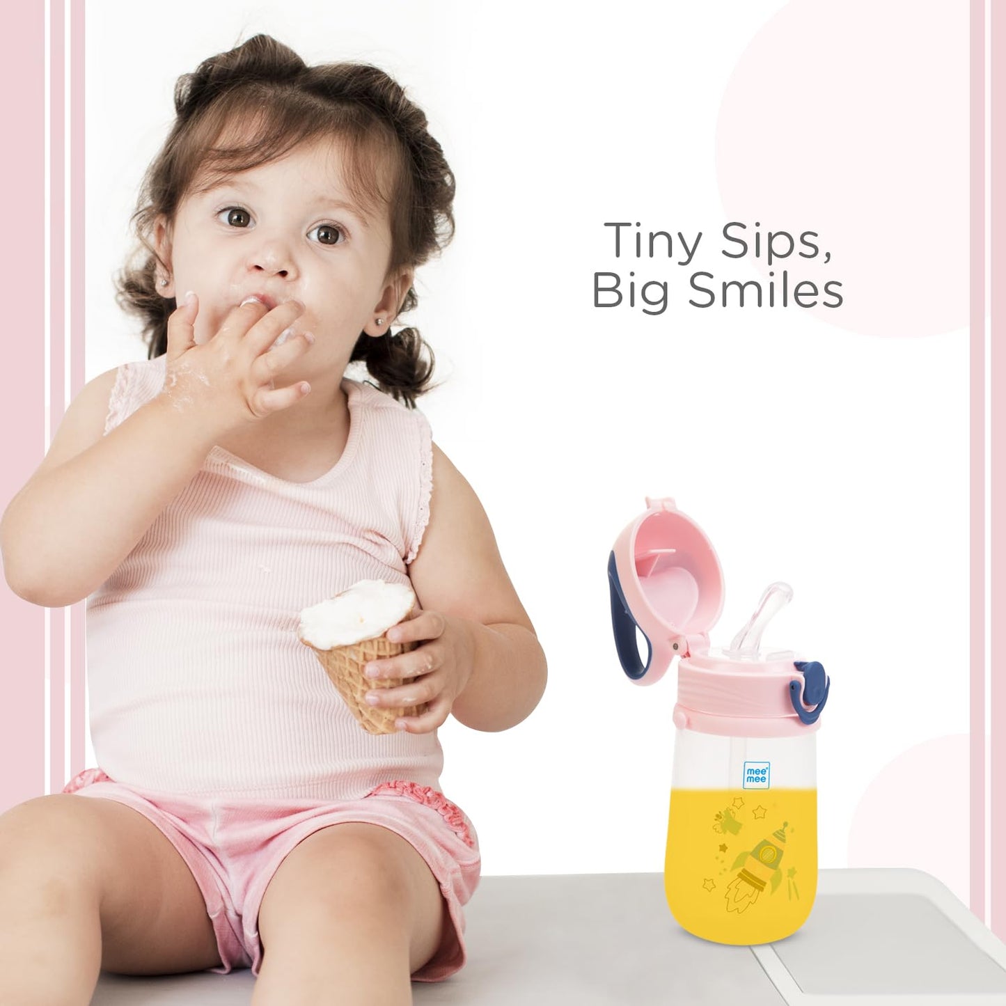 Toddler drinking from a Mee Mee pink straw sipper cup