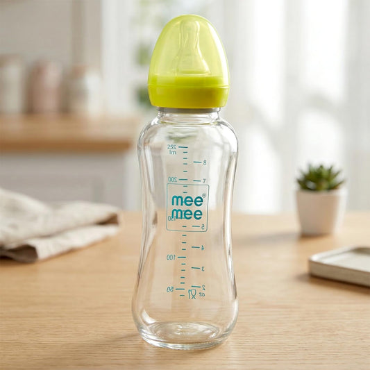 Mee Mee premium borosilicate glass feeding bottle with green cap on a table