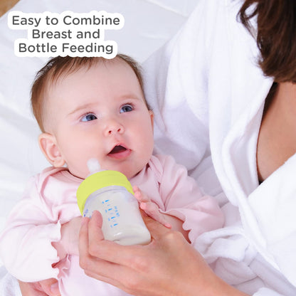 Mother feeding a baby with the Mee Mee borosilicate glass bottle