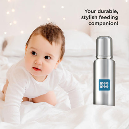 Baby lying beside the Mee Mee durable stainless steel feeding bottle