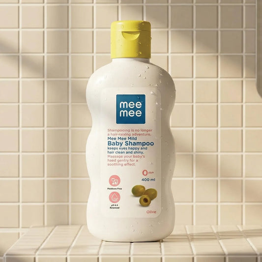 Mee Mee gentle tear-free baby shampoo bottle on a tiled bathroom surface