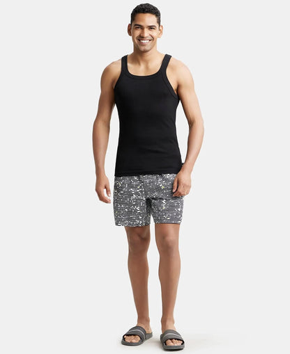 Full-length view of a model in a Jockey US26 black vest and printed shorts
