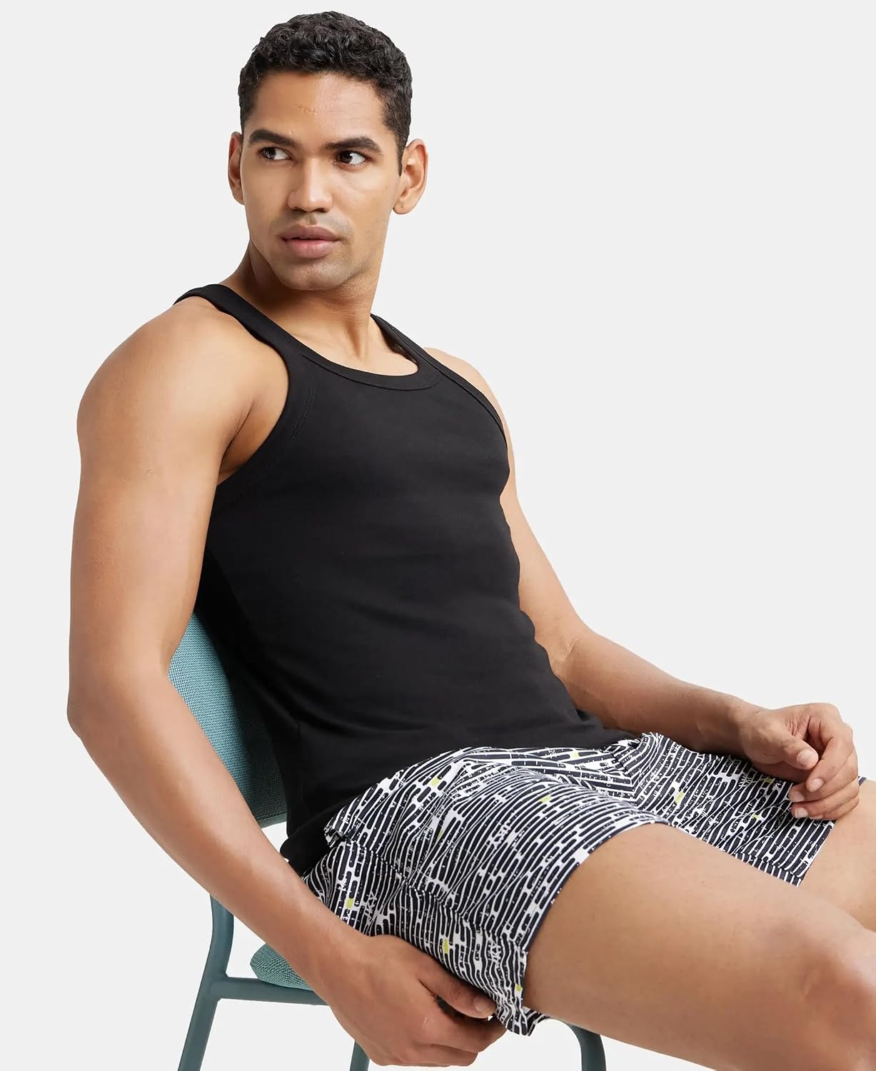 Model seated wearing a Jockey US26 black sleeveless cotton vest